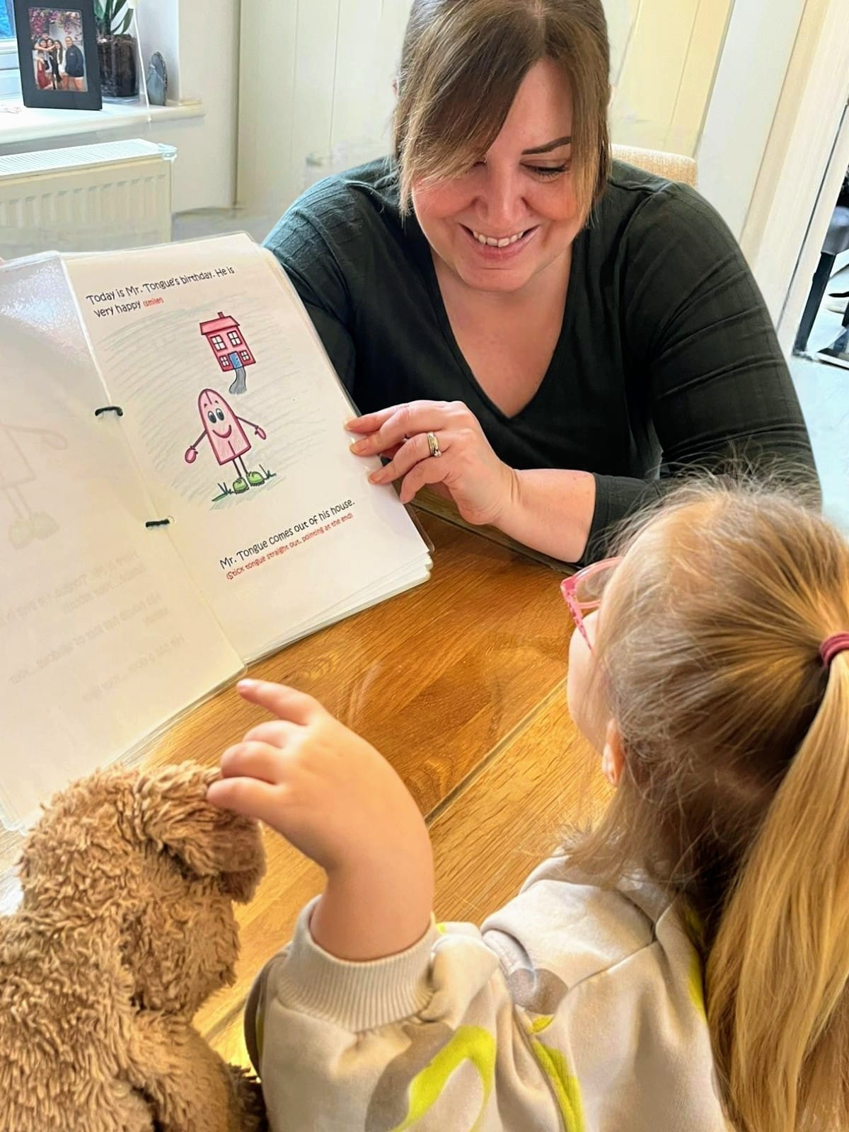 Speech therapist reading with a child during a therapy session